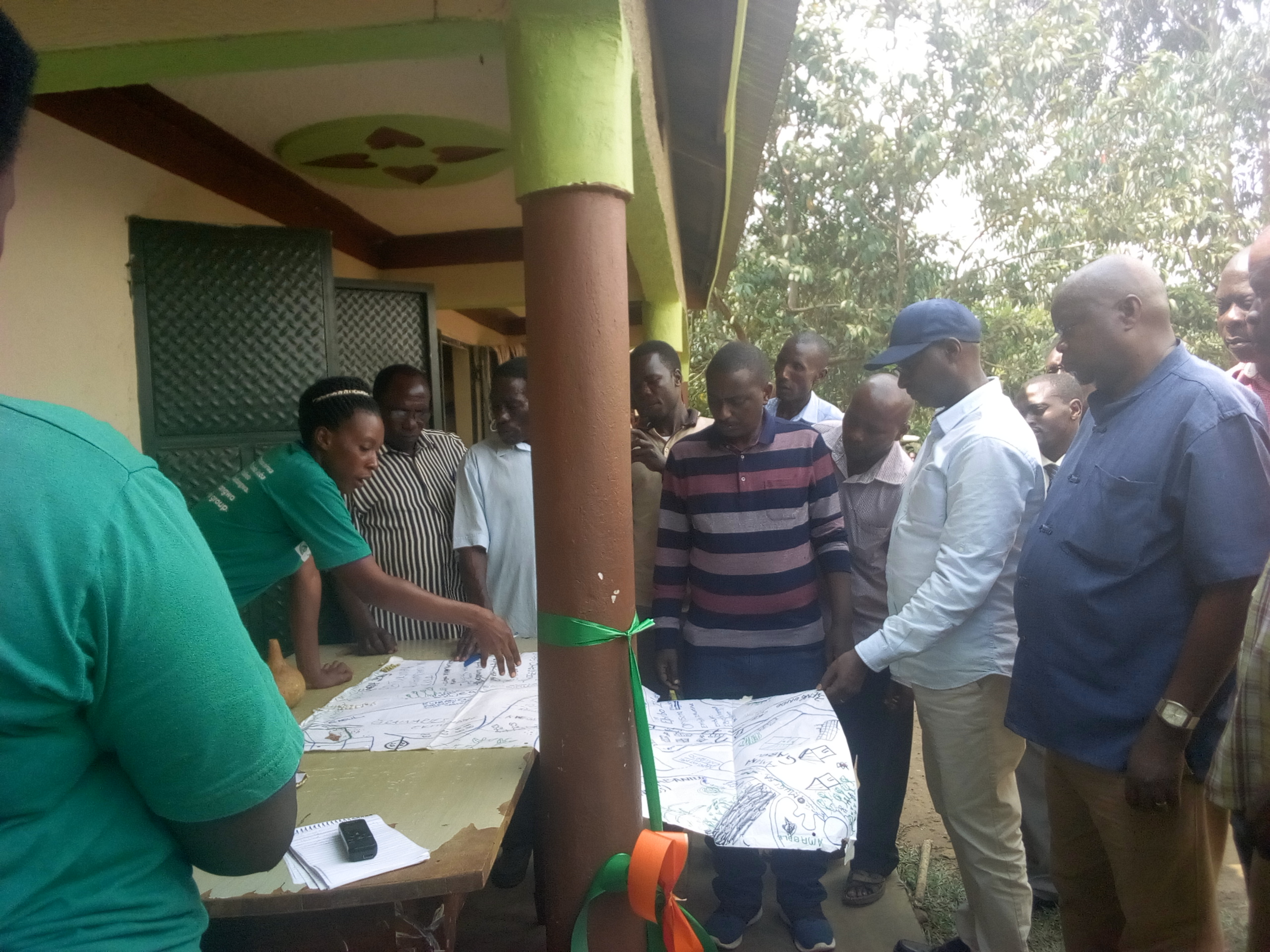 ED FRANK MURAMUZI,OSIEA C.D RICHARD MUGISHA,ALLAN KALANGI AND COMMUNITY MEMBERS ATTENDING TO PRESENTATION BY KASORO ANNET,CHAIRPERSON OF KABAALE WOMWN'S GROUP