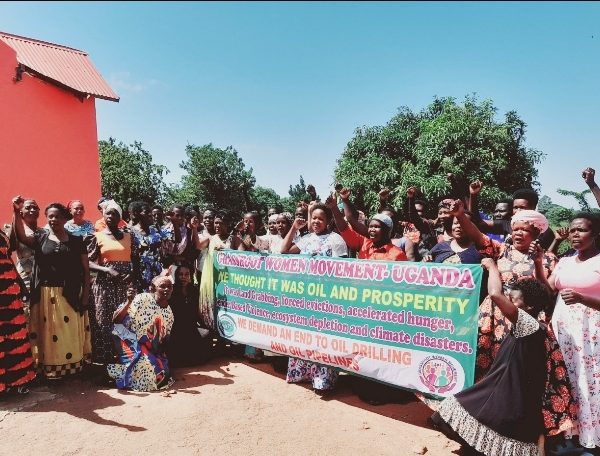 The women from the EACOP affected areas pose for a group photo after the outreach meeting with NAPE and the Community Green Radio staff in Buseruka Sub county Hoima District