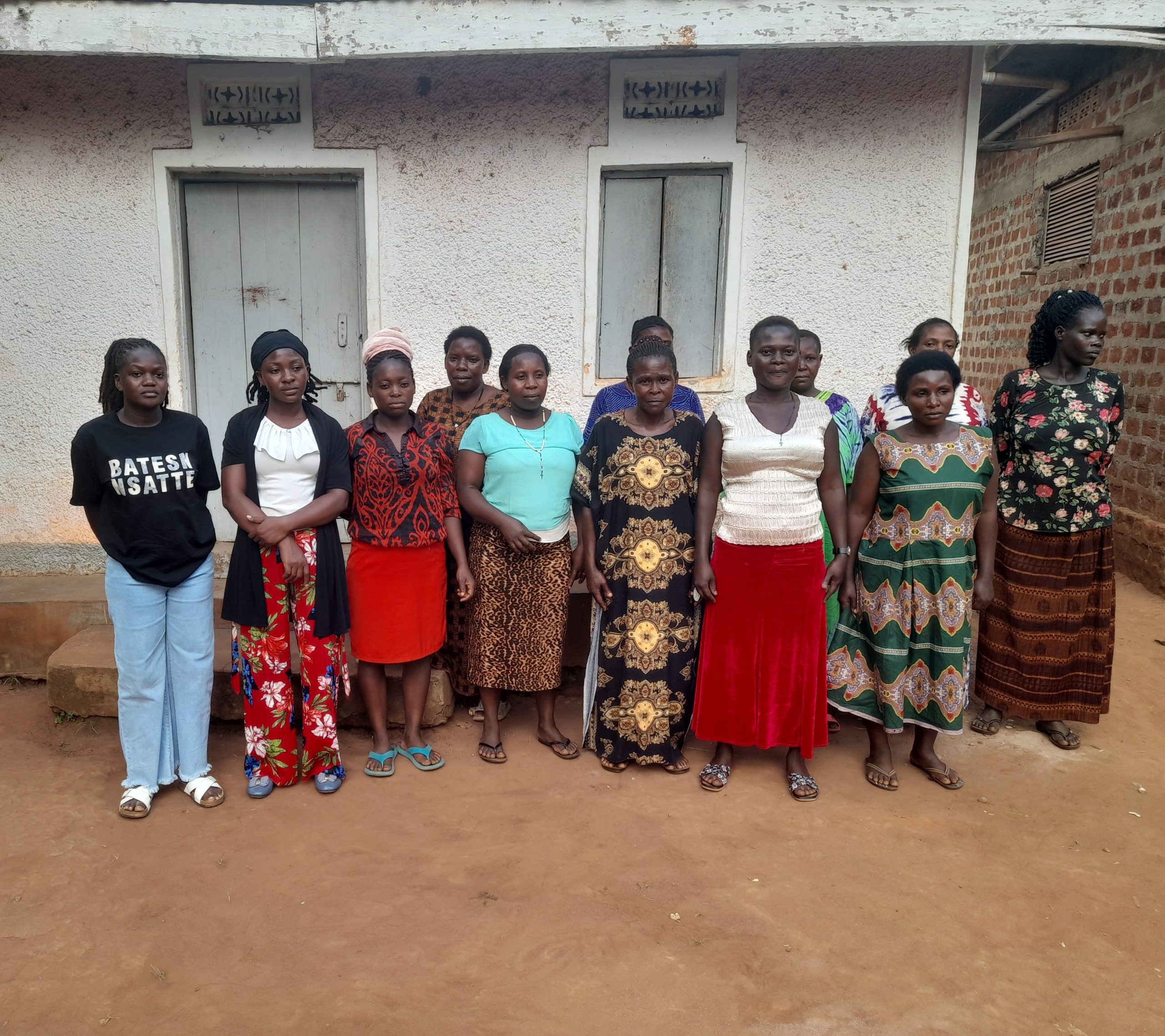 Our reporter, Nteza Joan(L) pose for a photo with Women affected by EACOP in Lwanda in Kiboga District.