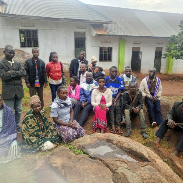 Community members pose for a photo with radio journalists during a community outreach in Kibiga, Kiboga District Central Uganda.