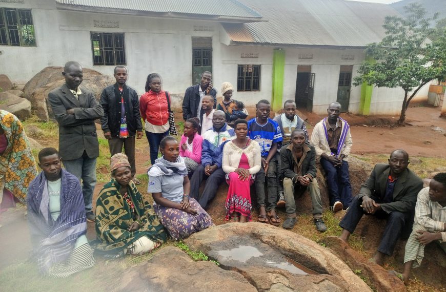 Community members pose for a photo with radio journalists during a community outreach in Kibiga, Kiboga District Central Uganda.