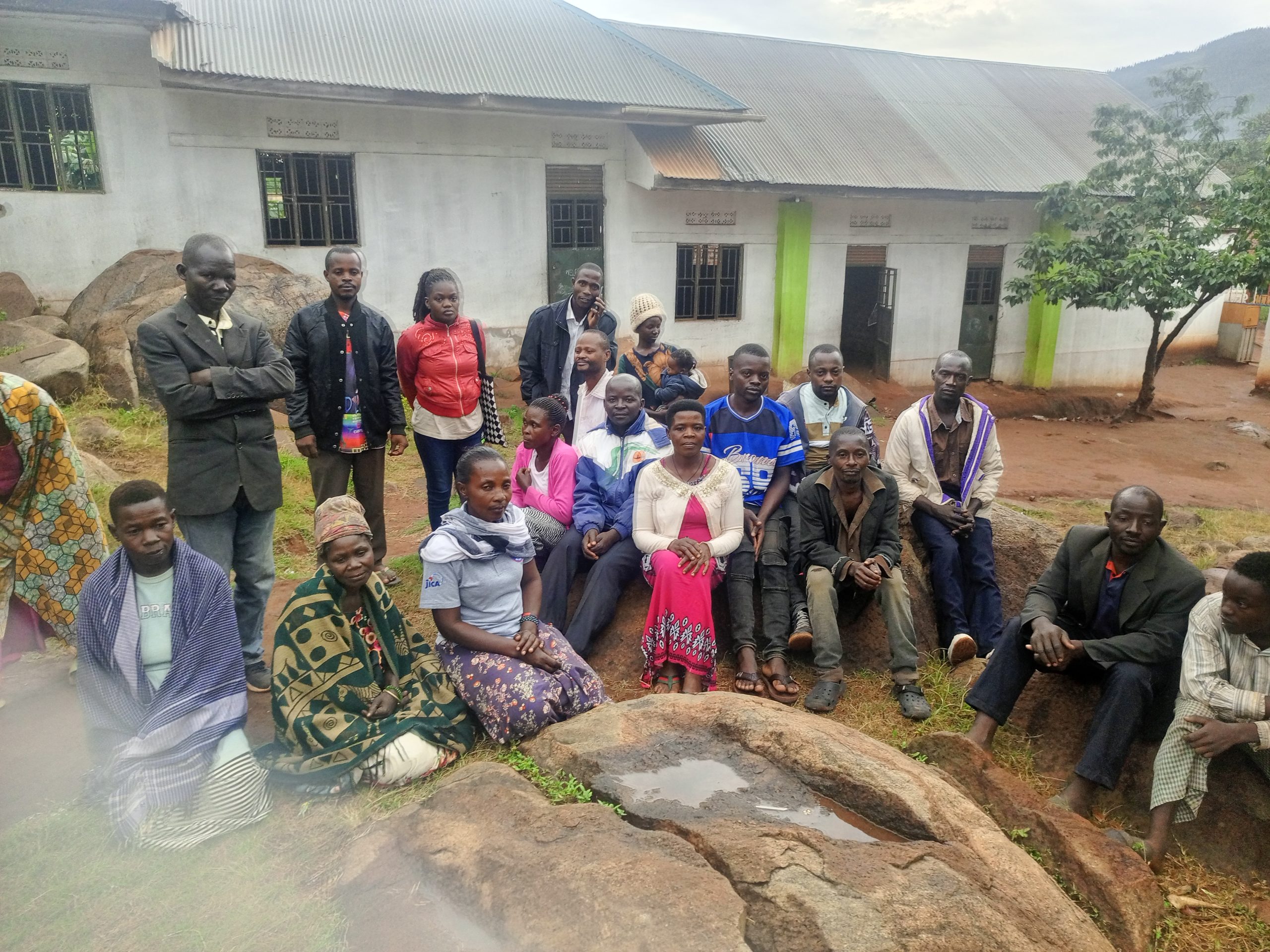 Community members pose for a photo with radio journalists during a community outreach in Kibiga, Kiboga District Central Uganda.